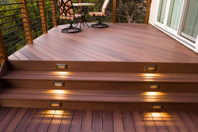 Warm-tone composite boards installed with hidden fasteners and low-voltage riser lights for safety and ambiance. A long-life, low-maintenance deck perfect for evening entertaining in Placerville, Camino, and El Dorado Hills.