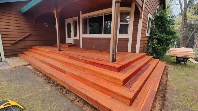 Warm, tiered entry steps with picture-frame edges, corrosion-resistant fasteners, and proper ledger flashing. A Placerville curb-appeal upgrade that blends craftsmanship and comfort with Sierra-ready performance.