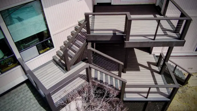 Complex, stacked-landing deck system with composite decking and cable guardrails. Maximizes usable square footage on a steep slope—code-compliant, low-maintenance construction by Apex Exteriors in El Dorado County.