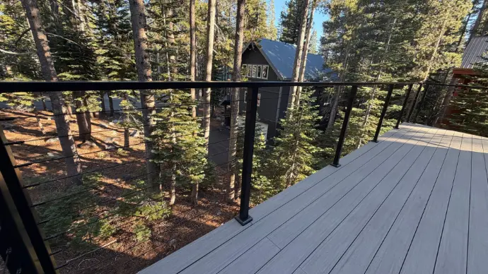 South Lake Tahoe deck featuring stainless cable railing and gray composite boards. Minimal visual obstruction, maximum durability—Apex Exteriors craftsmanship built for snow, sun, and mountain conditions.