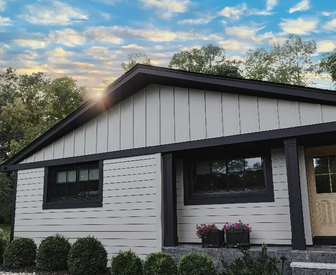 Clean exterior of two-tone house with clean shrubbery outside